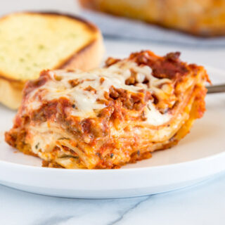 Homemade Lasagna Recipe - Looking for a classic lasagna recipe?  This traditional lasagna is just like mom used to make.  Comforting, delicious and full of cheesy goodness!