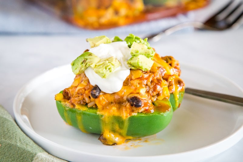 Easy Taco Stuffed Peppers - these Mexican stuffed peppers are a fun twist on a classic!  Taco meat, black beans, corn, salsa and more.  If you love taco night these are going to be a huge hit!