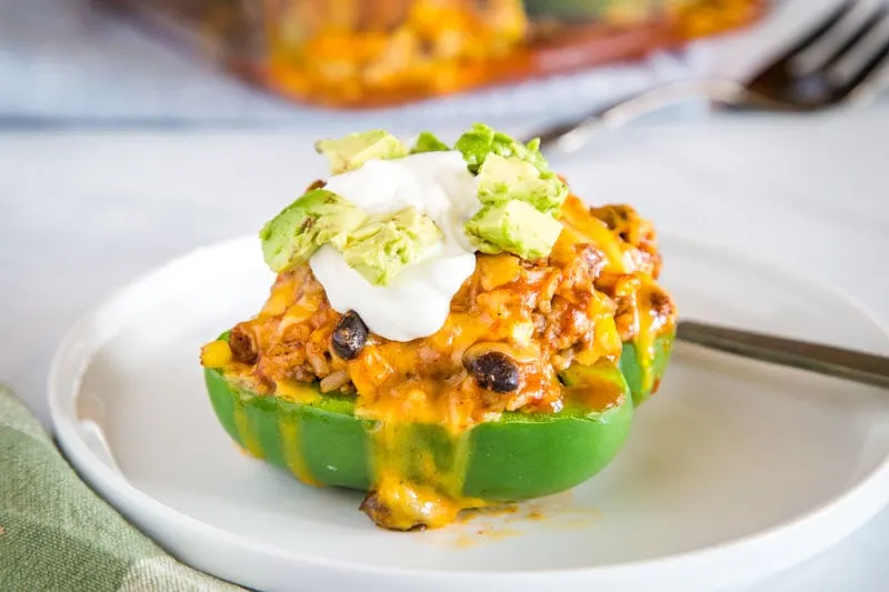 Easy Taco Stuffed Peppers - these Mexican stuffed peppers are a fun twist on a classic!  Taco meat, black beans, corn, salsa and more.  If you love taco night these are going to be a huge hit!