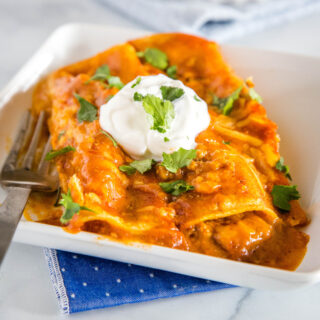 Easy Ground Beef Enchiladas - easy enchiladas filled with seasoned ground beef, onions, and lots of cheese! Absolutely delicious with just a few simple ingredients. Get a restaurant quality dinner on the table for dinner tonight! 