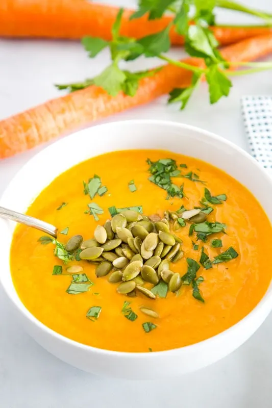 Easy soup recipe with carrots, ginger, garlic, and turmeric. Easy to make vegetarian or vegan.