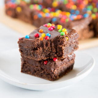 Cosmic Brownies - a homemade version of the childhood favorite.  Rich and fudgy brownies topped with a chocolate fudge frosting and rainbow sprinkles. 
