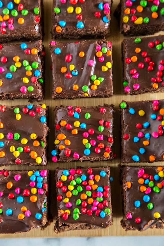 Fudgy brownies topped with a chocolate ganache and topped with sprinkles. 