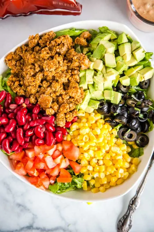 Use taco meat and Doritos to make this salad over the top good.