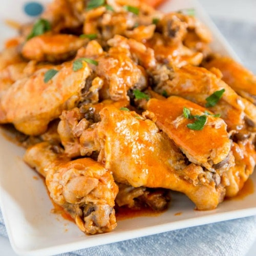 A close up of chicken wings on a plate, with Chicken