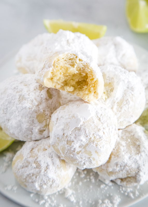 Lime Cooler Cookies - Melt in your mouth cookies flavored with lots of lime and coated in powdered sugar. They are light and fluffy and perfect all year round!