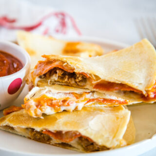 Pizza Quesadilla - Turn your favorite pizza into a quesadilla for a quick and easy dinner tonight!  Fill with pepperoni, sausage, peppers, black olives, or whatever your favorite is!  