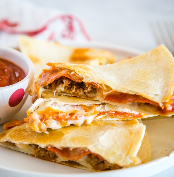 Pizza Quesadilla - Turn your favorite pizza into a quesadilla for a quick and easy dinner tonight!  Fill with pepperoni, sausage, peppers, black olives, or whatever your favorite is!  