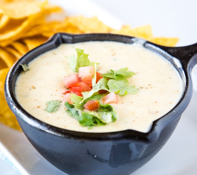 Mexican White Queso Dip - Similar to the white cheese sauce served at Mexican restaurants. It is creamy, has just a little spice to it and is the perfect addition to any party!  