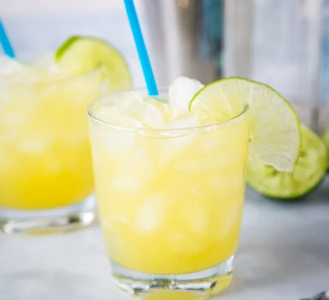A glass of margarita with slice of lime, with Margarita