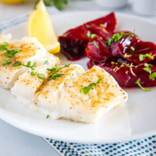 Easy Baked Cod - an easy oven baked cod recipe that is lightly seasoned and topped with melted butter!  Served with Harvard Beets for a delicious meal.