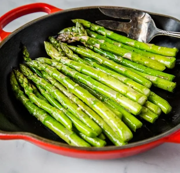 Sauteed Asparagus - super simple side dish with asparagus sauteed in butter, garlic and seasoned with salt and pepper.  Ready in just minutes, healthy, and goes with just about everything.  