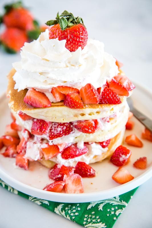 Pancakes are a great weekend breakfast topped with strawberries and whipped cream