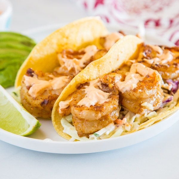 shrimp tacos on a plate, with Chipotle and Taco