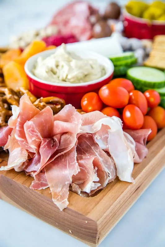 Proscuitto and grape tomatoes on a meat and cheese board