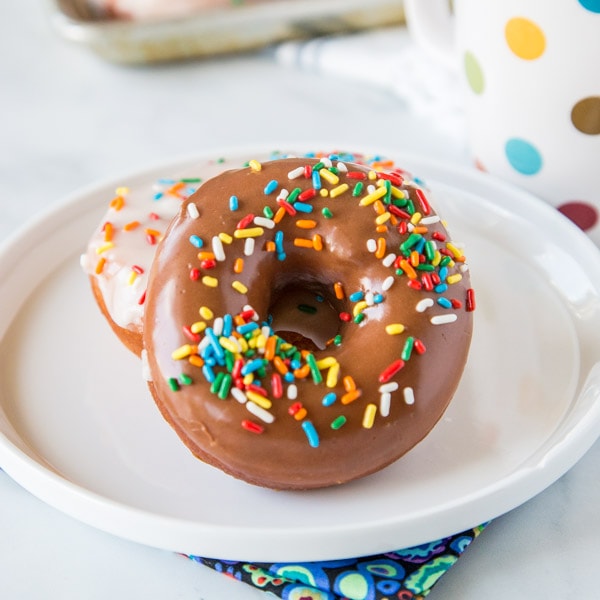 Homemade Donuts - soft and fluffy yeast donuts you can make in your own kitchen!  Just like going to the bakery only warm and delicious at home.  Top with chocolate, vanilla, or dust in cinnamon sugar.  Even fill them with cream or jelly. The options are endless!