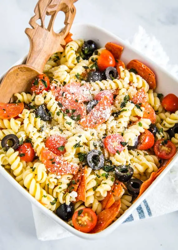 pasta salad with olives, pepperoni, tomatoes, and italian dressing