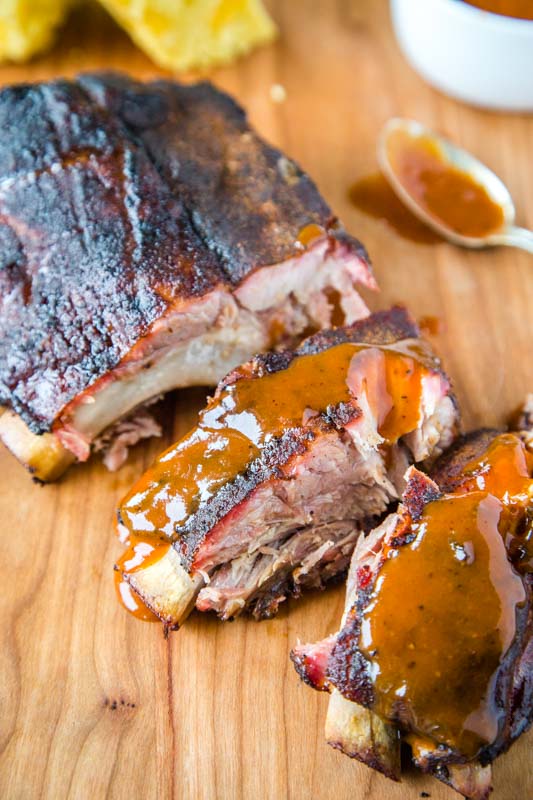Smoked baby back ribs brushed with barbecue sauce
