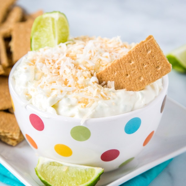 Coconut Lime Cheesecake Dip - a super easy no bake treat that is light, creamy, and absolutely delicious!  Sweet and tart with lots of toasted coconut.  Great with graham crackers or even fruit!