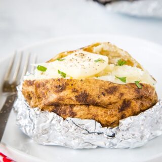 baked potato with butter on a plate