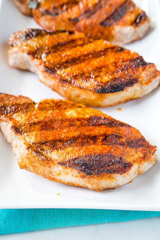 seasoned grilled pork chops on white plate