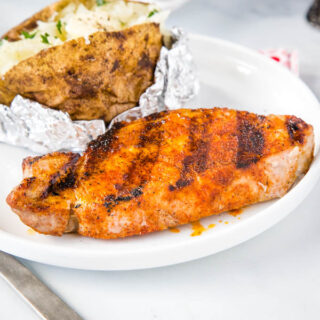 Grilled Pork Chops - super easy pork chops that are seasoned with a few simple spices and then grilled to perfection.  Juicy, tender, and the perfect easy summer dinner.