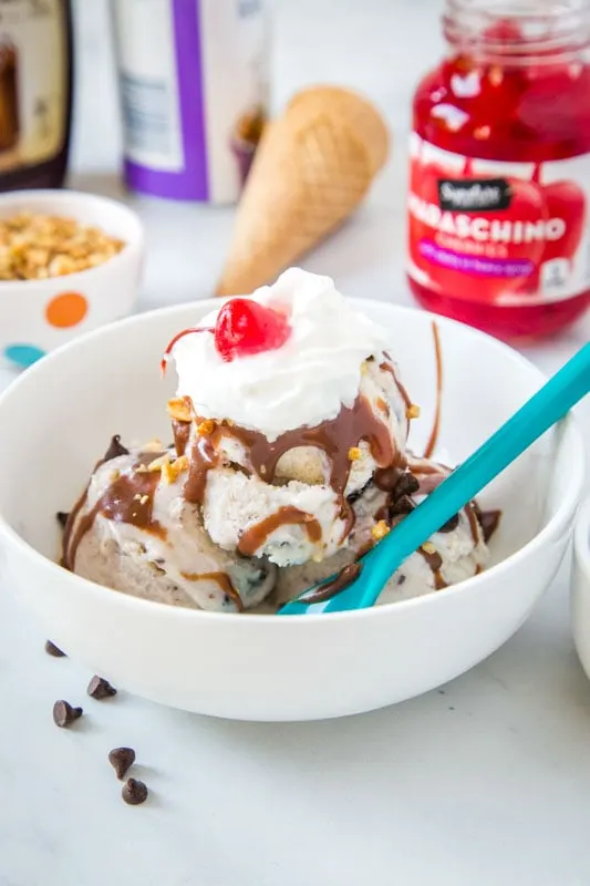 make your own ice cream sundae with chocolate sauce, whipped cream and a cherry