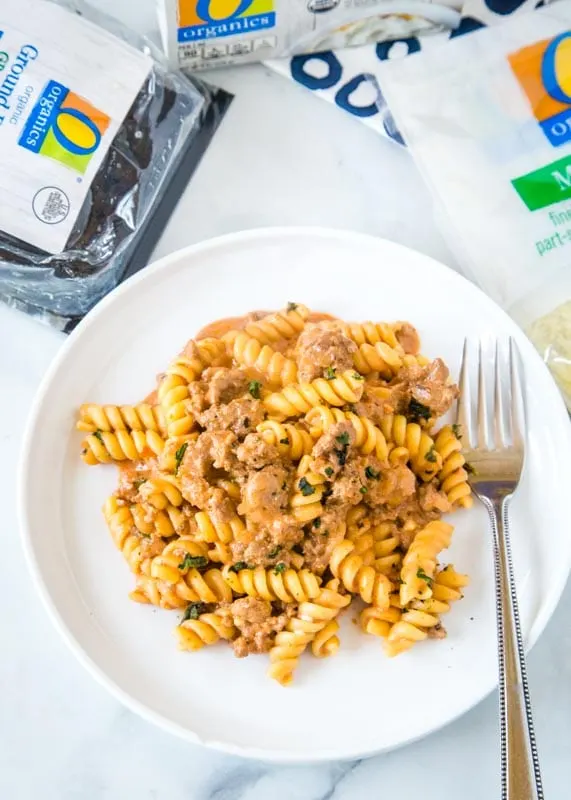 pasta on a plate with package of ground beef, cream cheese and bag of cheese on the side