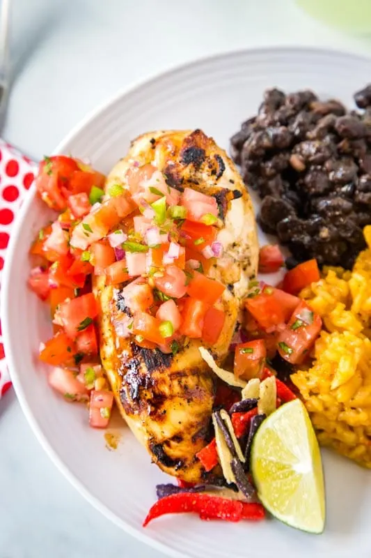 grilled chicken on plate with black bean and rice
