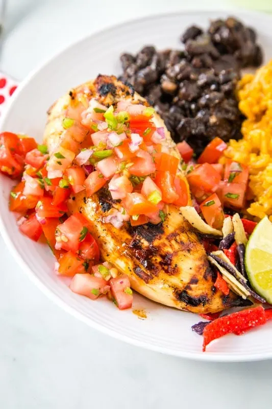 margarita chicken with pico de gallo served with black beans and mexican rice