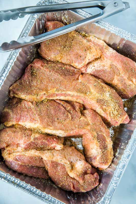 country style ribs rubbed with spices in pan