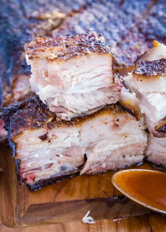 smoked pork belly cut into cubes on cutting board