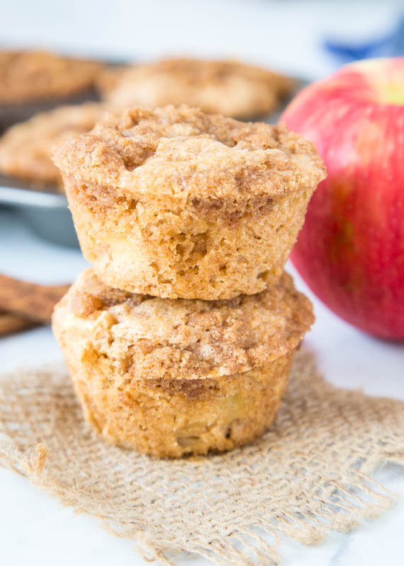 stacked apple muffins with an apple and cinnamon sticks