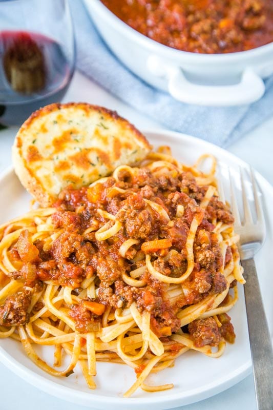 pasta with bolognese sauce on white plate