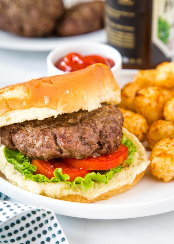 hamburger on bun with lettuce and tomato