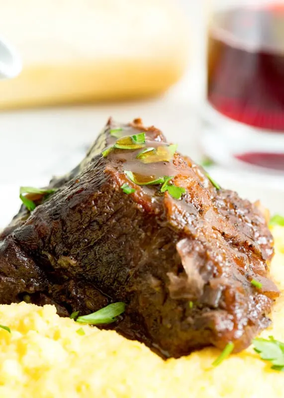 beef short rib with sauce over polenta