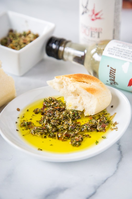 olive oil bread dip with bottle of wine
