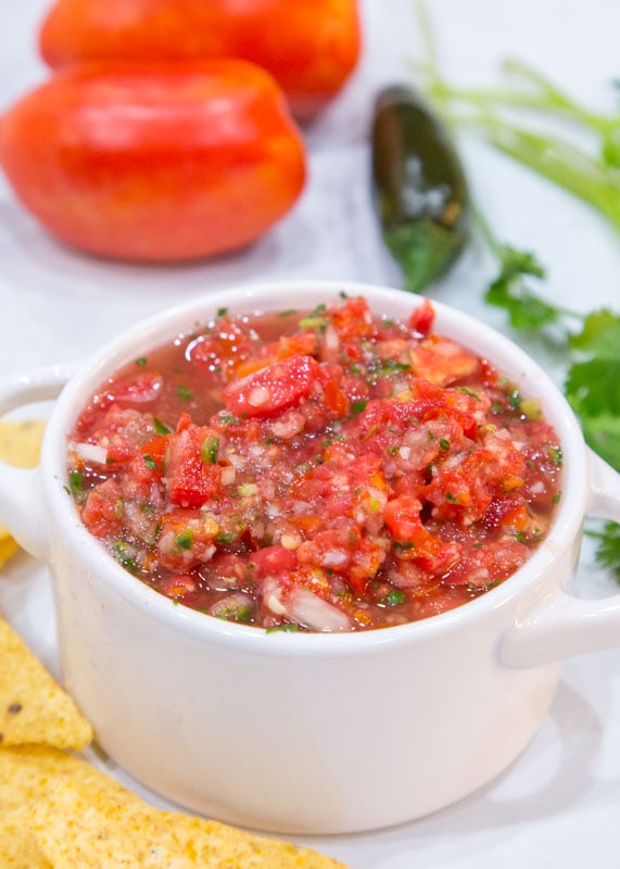 homemade salsa in white bowl with chips