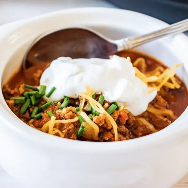 close up of turkey chili in white bowl