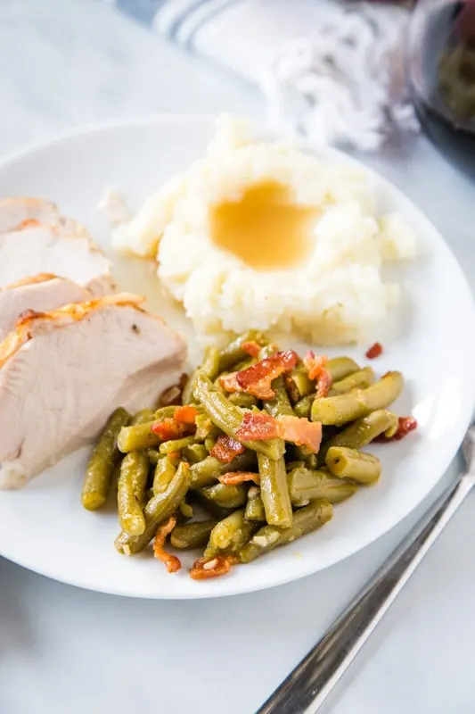 looking down on plate of green beans with turkey and potatoes