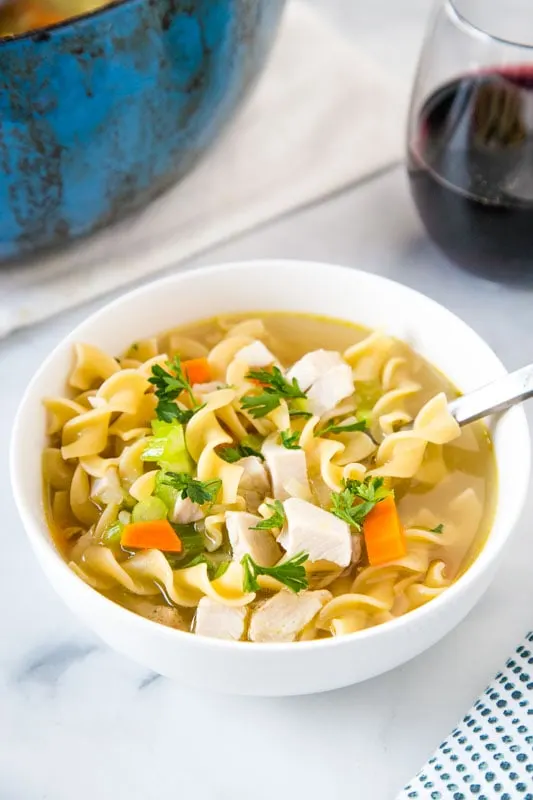 bowl of turkey noodle soup with spoon