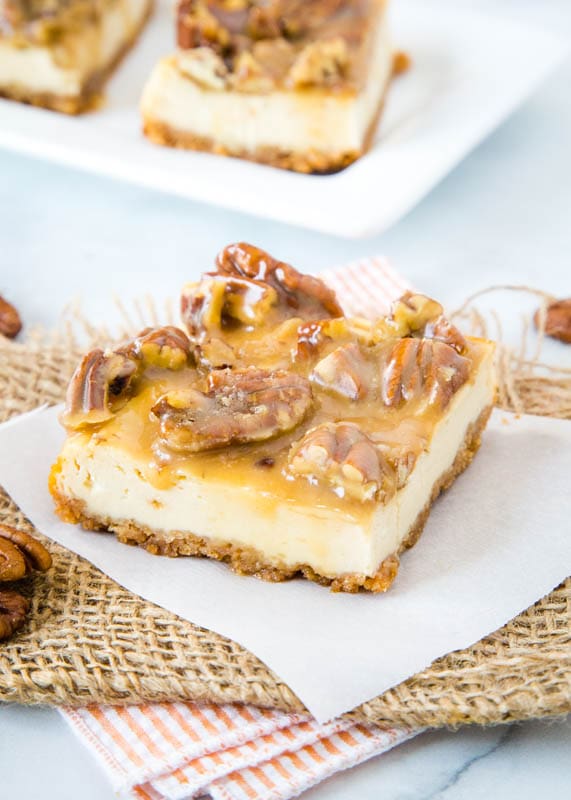brown sugar cheesecake bars topped with pecan praline