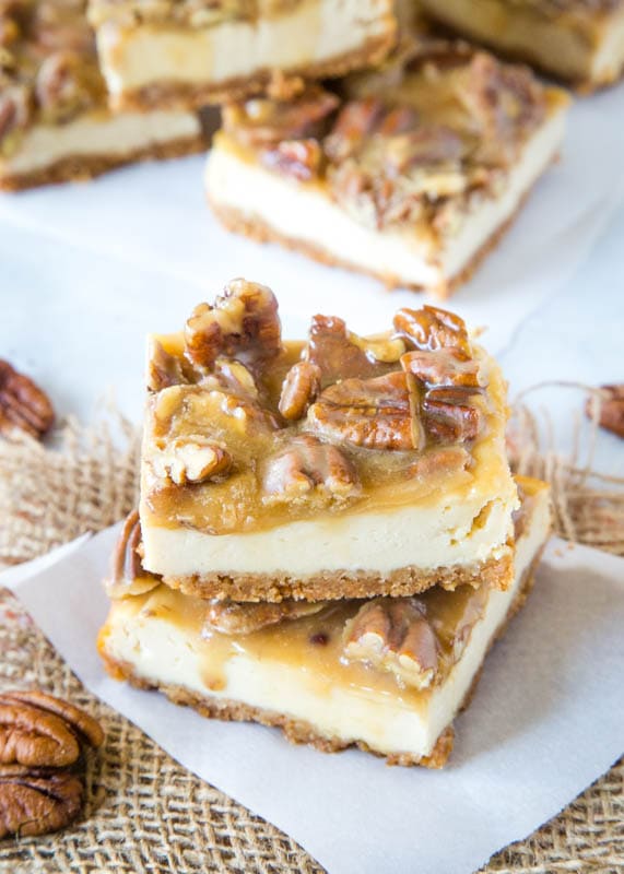 praline cheesecake bars on white paper