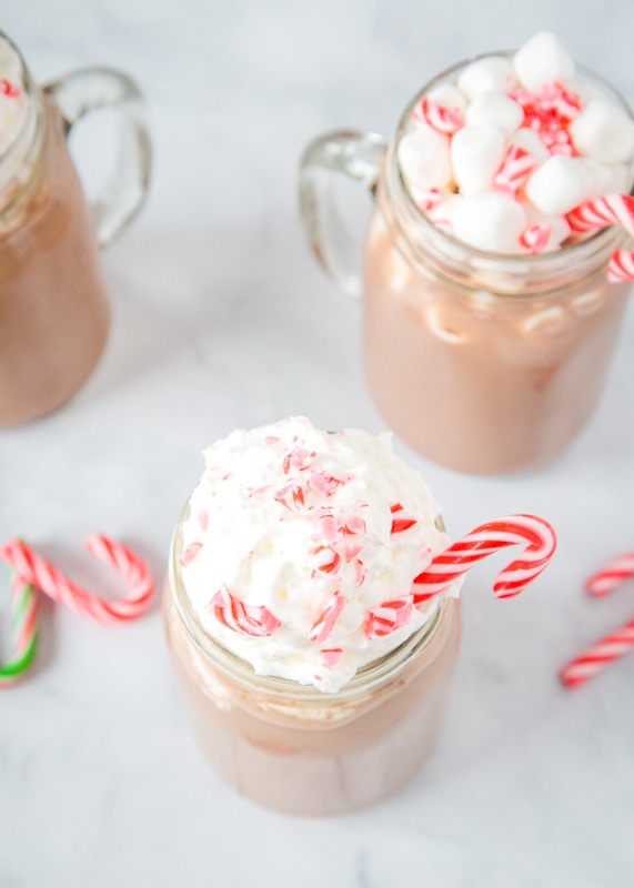 looking down at hot chocolate topped with whipped cream and candy canes