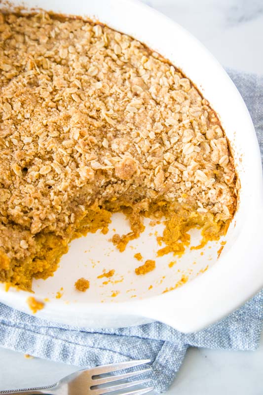 pumpkin crisp in casserole dish with piece missing