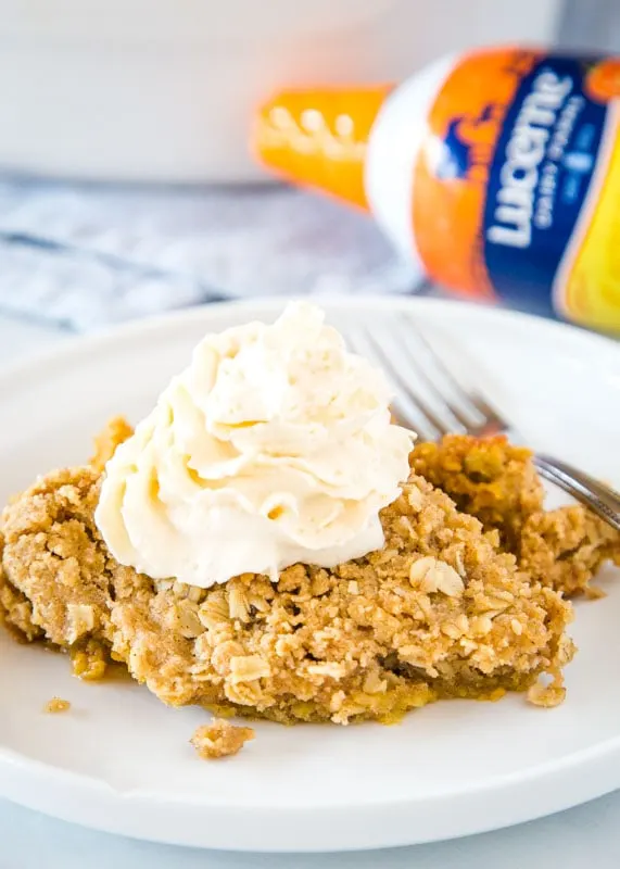 pumpkin crisp on plate with whipped cream and fork