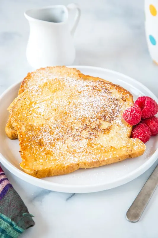 french toast on plate dusted with powdered sugar