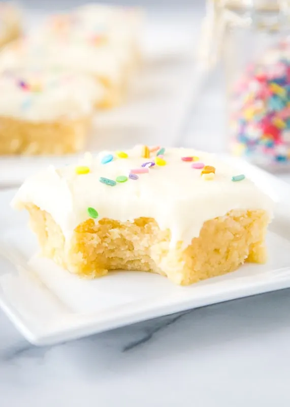 sugar cookie bar on white plate with bite taken out of it