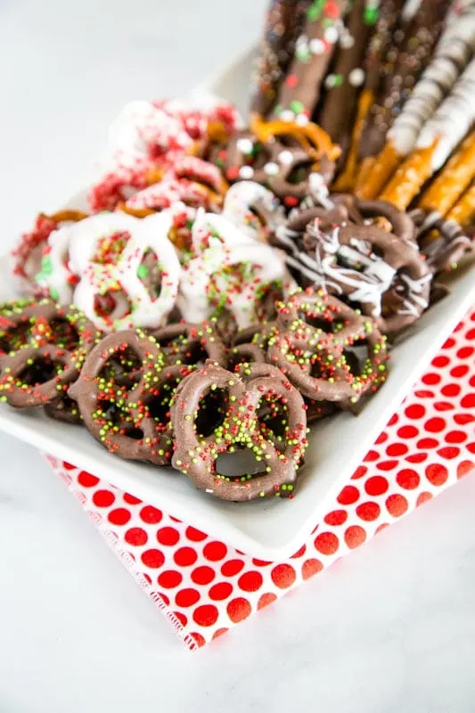 chocolate covered pretzels on white plate`
