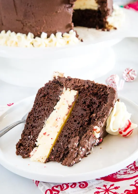 slice of chocolate peppermint cheesecake cake on a white plate